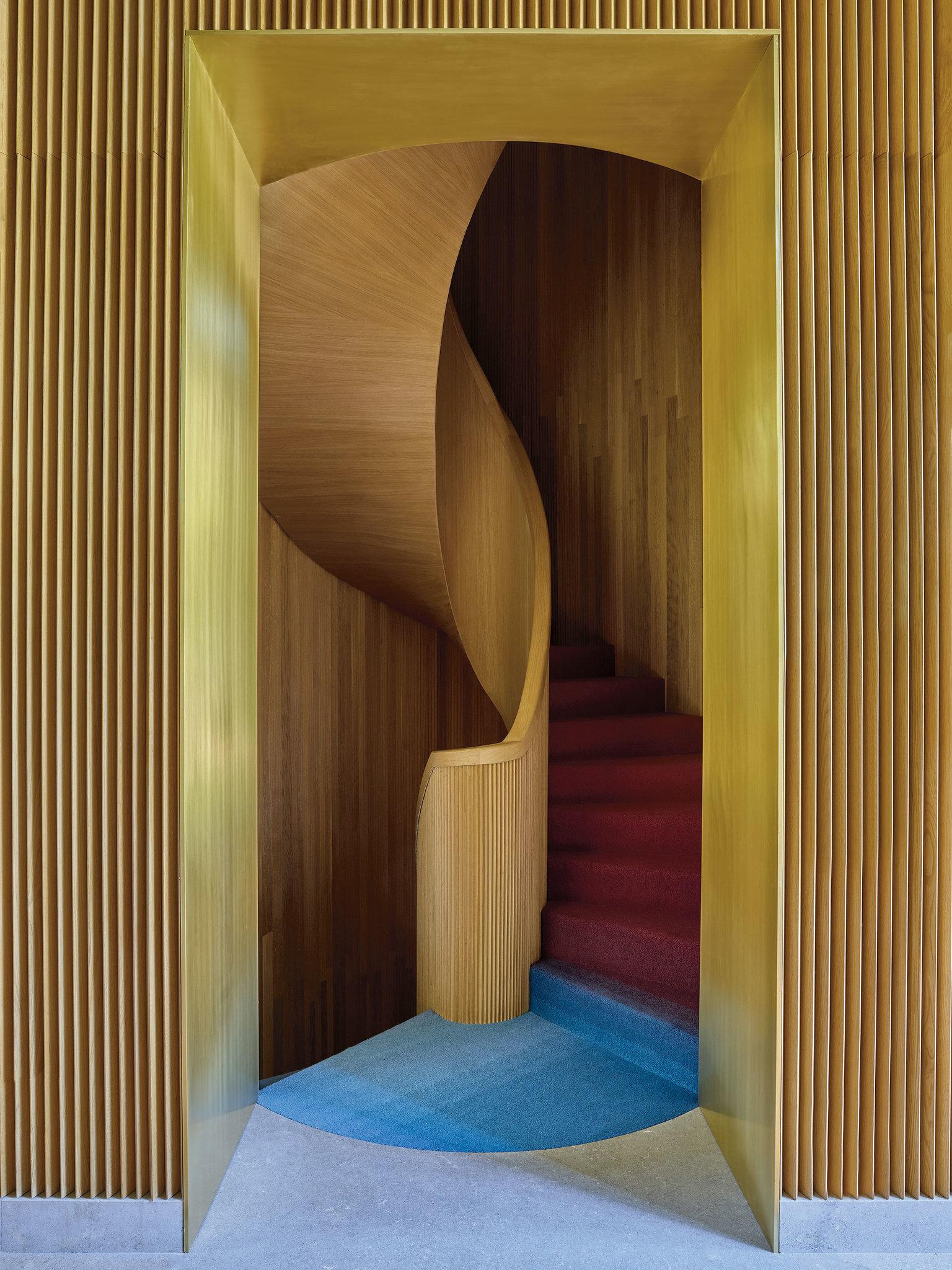 Spiral staircase designed by Luca Guadagnino covered with an ombré carpet by La Manufacture Cogolin