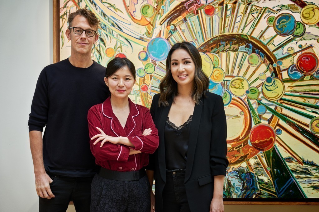 CFHILL's Michael Elmenbeck together with 'Mountains & Streams' curators Shi Zheng and Melanie Lum in front of a work by You Jin