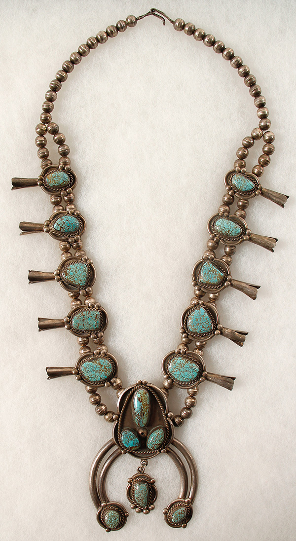 Outstanding vintage Navajo Squash Blossom necklace boasting 16 beautiful turquoise nuggets from the #8 mine in Eureka county, Nevada ($2,500).
