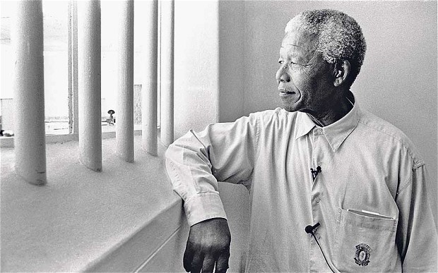 The Nobel Peace Prize winner posed in the cell where he spent 18 of his 27 years of imprisonment. Robben Island, South Africa, 1994, image © Jürgen Schadeberg