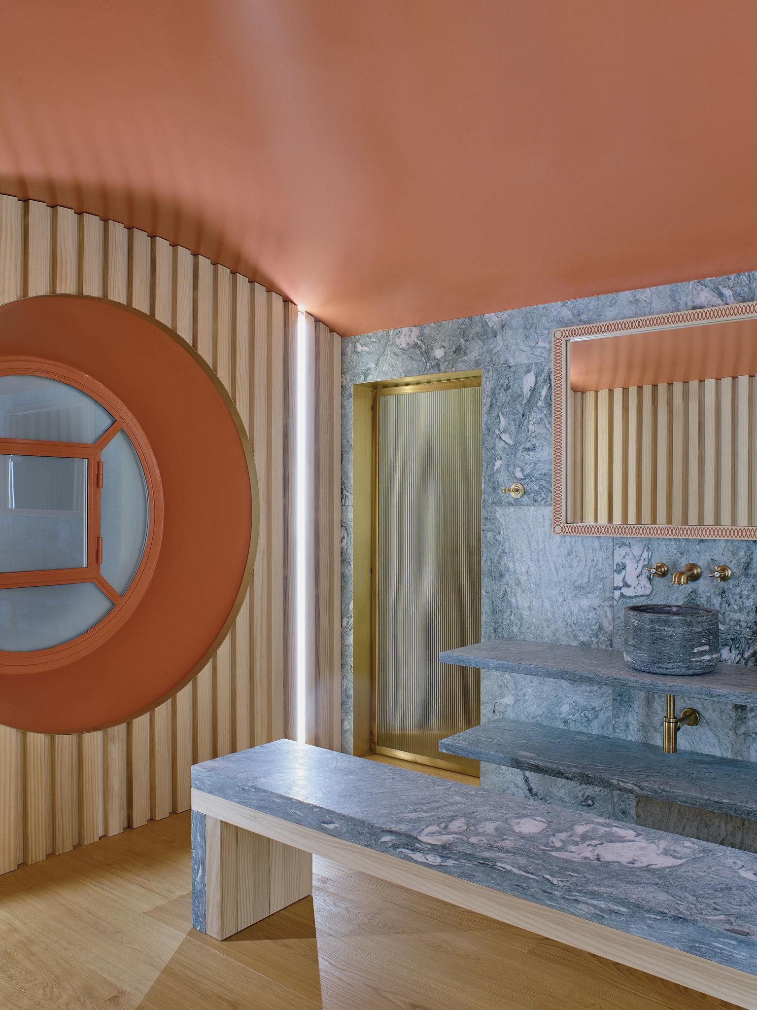 A nautical bathroom that leads to the indoor pool, Studio Luca Guadagnino. Photo: Henry Bourne