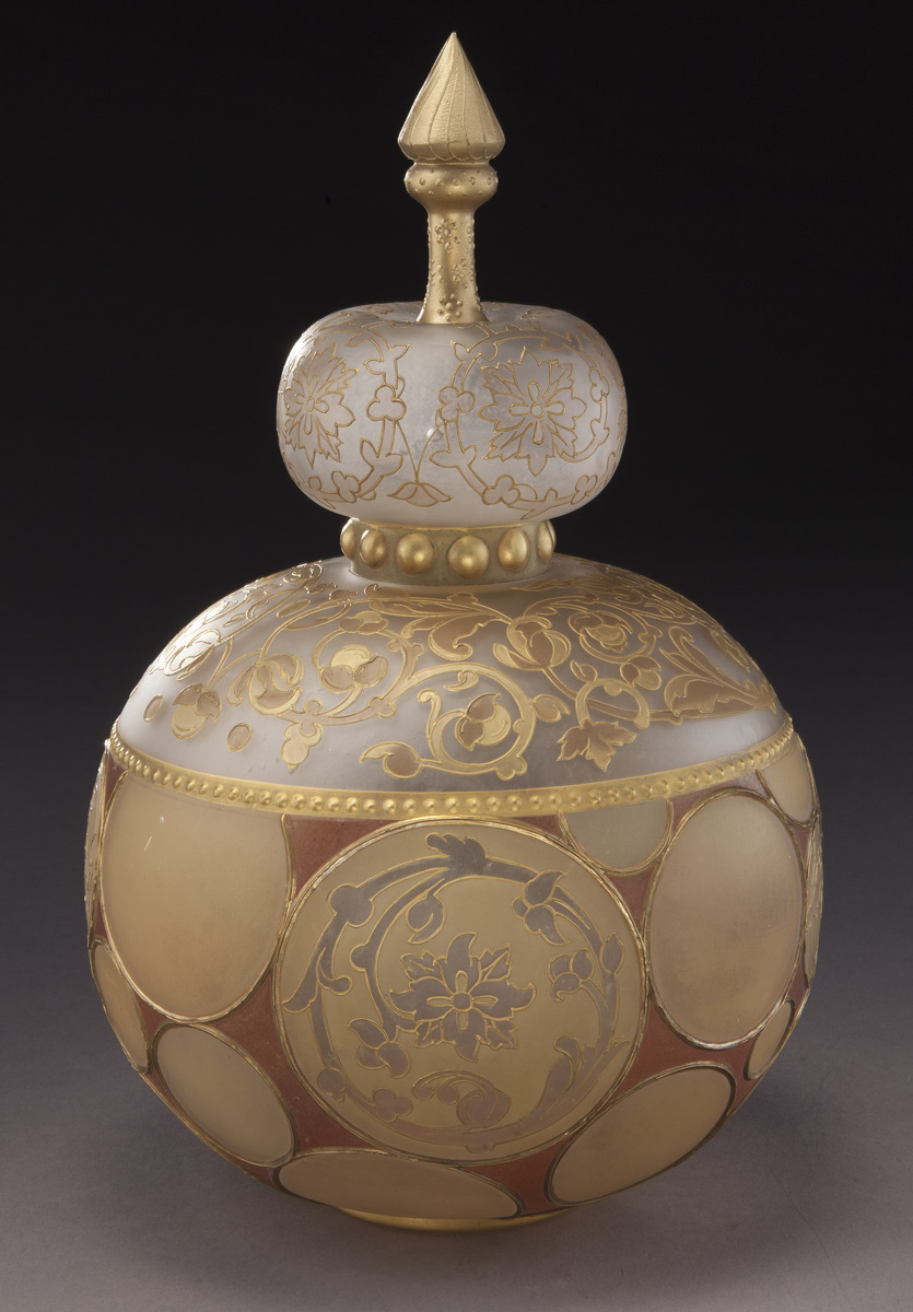 Mt. Washington Royal Flemish covered jar decorated with circular medallions and fitted with a crown finial. 11.5” H, Est. - $3,000 - $6,000