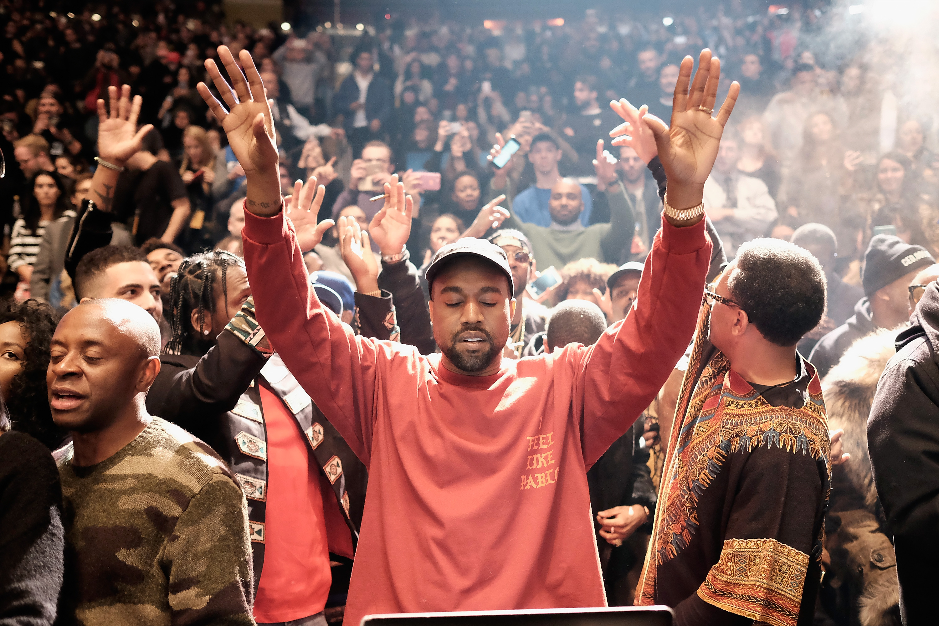 Kanye West performs during Kanye West Yeezy Season 3 wearing the pop-up collection Image via Inverse