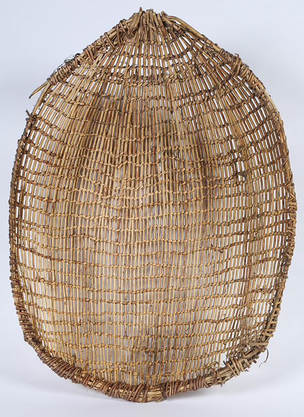Large, circa 1900 winnowing basket, 28 ½ inches long by 21 ½ inches wide, with open basket twining, utilitarian (but never utilized), a pine nut harvest relic from the Great Basin ($1,750).